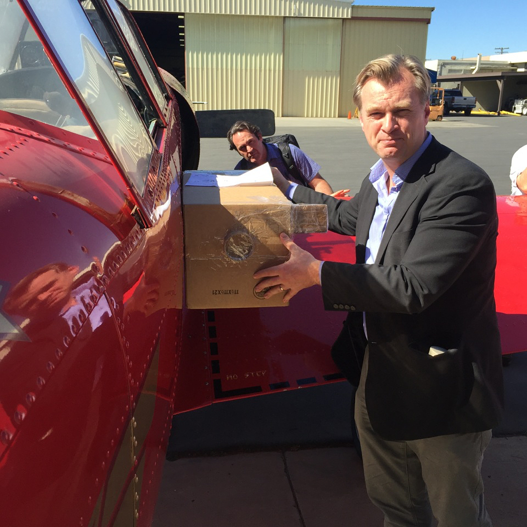 Director Christopher Nolan supervising camera planes on set